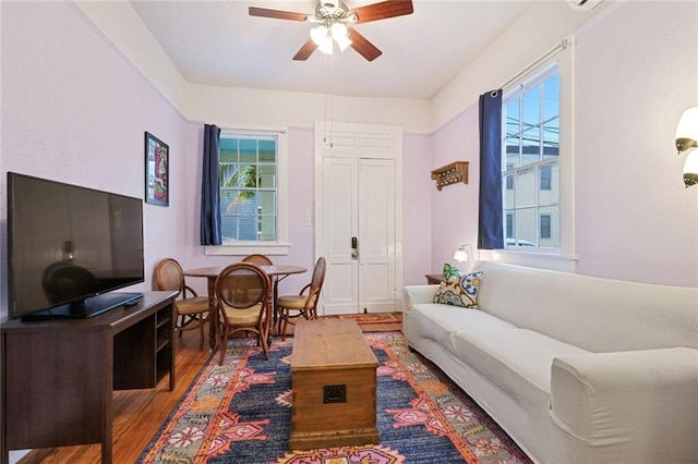 living room with ceiling fan and wood finished floors