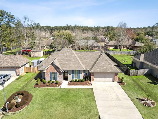 ranch-style house featuring concrete driveway, a garage, fence, and brick siding