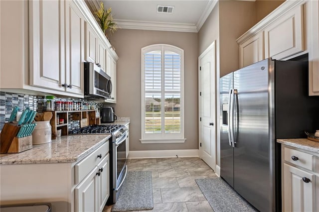 kitchen featuring visible vents, appliances with stainless steel finishes, crown molding, decorative backsplash, and baseboards