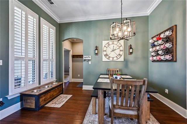 dining space featuring visible vents, baseboards, ornamental molding, arched walkways, and a notable chandelier