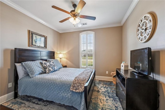 bedroom featuring visible vents, dark wood-type flooring, crown molding, baseboards, and a ceiling fan