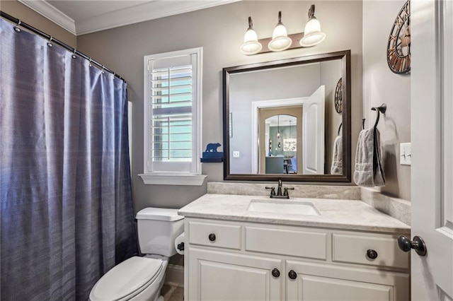 bathroom with vanity, crown molding, and toilet