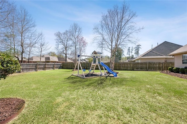 view of yard featuring a playground and a fenced backyard