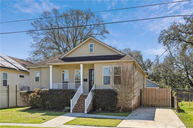 bungalow-style house with covered porch, fence, stairway, a gate, and a front yard