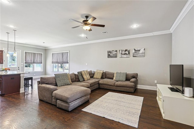 living room with ornamental molding, dark wood-style flooring, visible vents, and baseboards