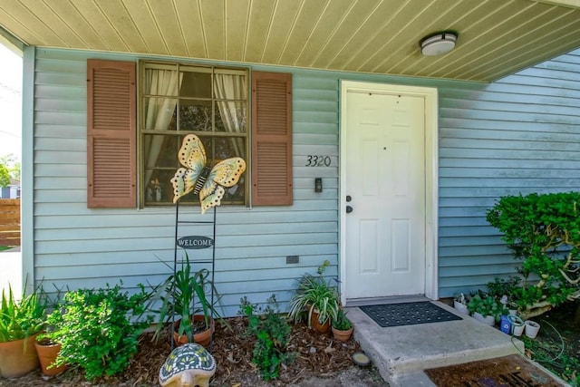 view of exterior entry with covered porch