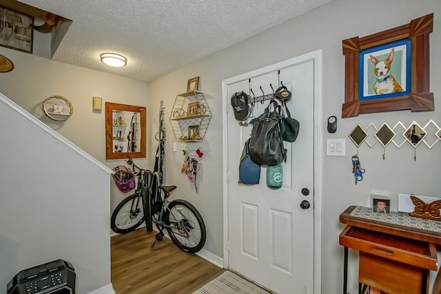 entryway featuring a textured ceiling and wood finished floors