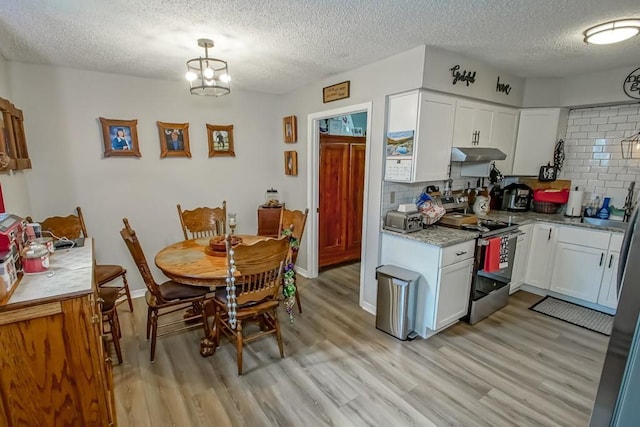 kitchen featuring under cabinet range hood, electric range, white cabinetry, and light wood finished floors