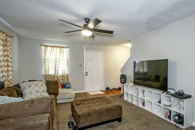 living area with carpet, a textured ceiling, and a ceiling fan