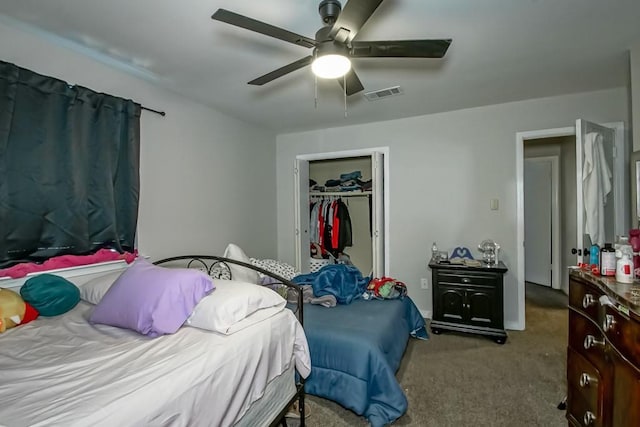 carpeted bedroom featuring ceiling fan, visible vents, and a closet