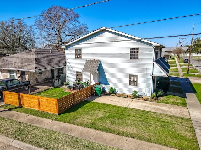 exterior space featuring fence and a yard