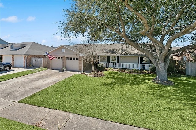 ranch-style home with fence, a porch, concrete driveway, and a front yard