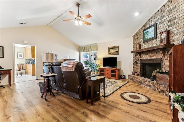 2243 E Canterbury Dr, La Place, LA 70068 - living room featuring visible vents, a ceiling fan, a brick fireplace, vaulted ceiling, and wood finished floors