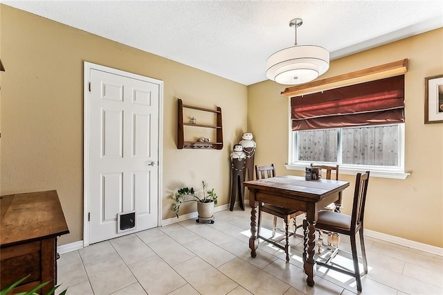2243 E Canterbury Dr, La Place, LA 70068 - dining area with light tile patterned floors, baseboards, and a textured ceiling