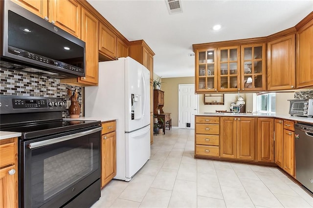 2243 E Canterbury Dr, La Place, LA 70068 - kitchen featuring brown cabinets, visible vents, electric range, and stainless steel dishwasher