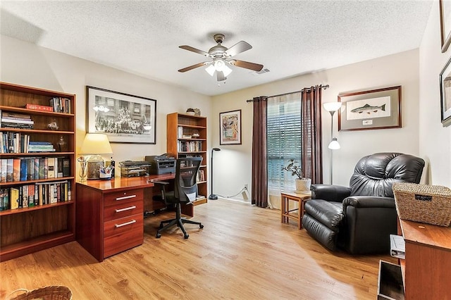 2243 E Canterbury Dr, La Place, LA 70068 - office area featuring light wood-type flooring, ceiling fan, and a textured ceiling