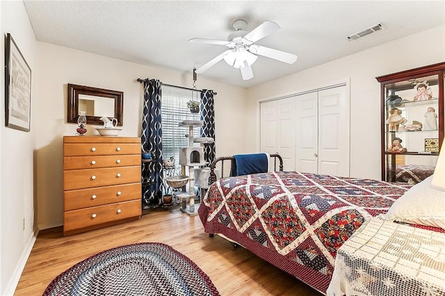 2243 E Canterbury Dr, La Place, LA 70068 - bedroom featuring a textured ceiling, visible vents, baseboards, a closet, and light wood-type flooring