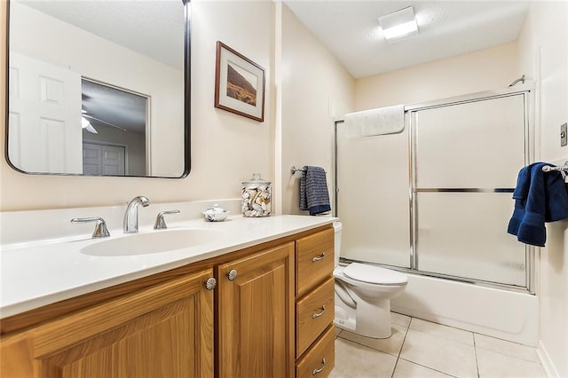 2243 E Canterbury Dr, La Place, LA 70068 - bathroom featuring toilet, vanity, combined bath / shower with glass door, and tile patterned floors