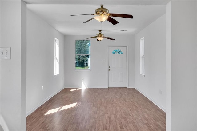 entrance foyer with wood finished floors, visible vents, and baseboards