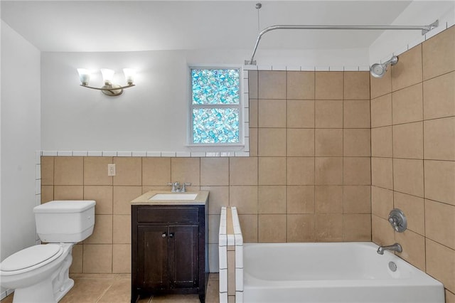 bathroom with shower / bathing tub combination, tile walls, toilet, and vanity