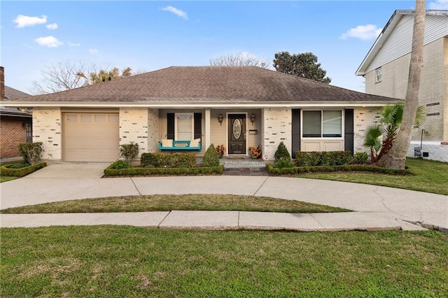 ranch-style house featuring driveway, a garage, a shingled roof, covered porch, and a front yard