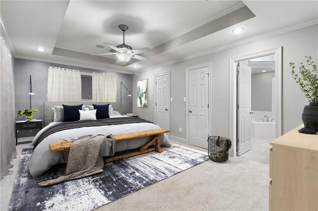 bedroom featuring ensuite bathroom, recessed lighting, carpet flooring, ornamental molding, and a raised ceiling