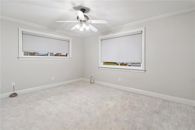 carpeted empty room with ornamental molding, ceiling fan, and baseboards