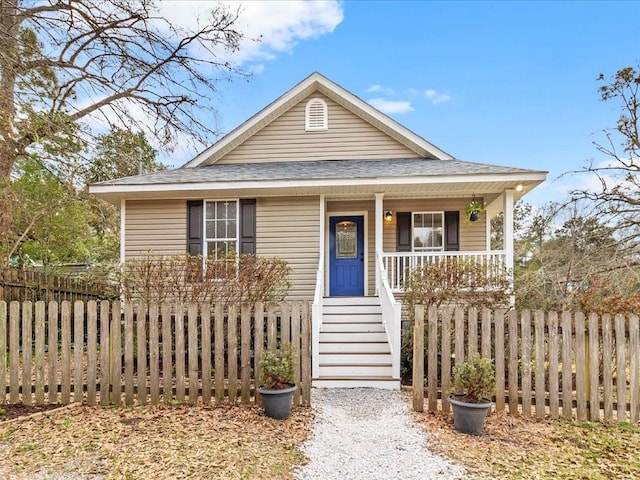 bungalow with stairs, a porch, roof with shingles, and fence