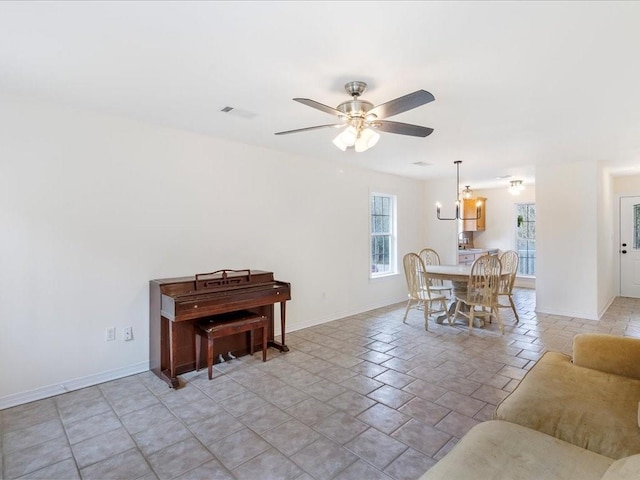 dining area with visible vents, baseboards, and ceiling fan with notable chandelier