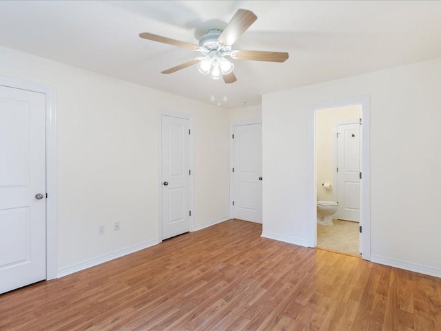 unfurnished bedroom with ensuite bath, light wood-style flooring, baseboards, and ceiling fan