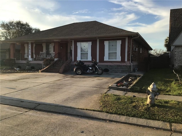 view of front of home with covered porch and roof with shingles