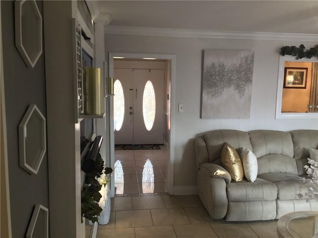 tiled entrance foyer with crown molding and baseboards