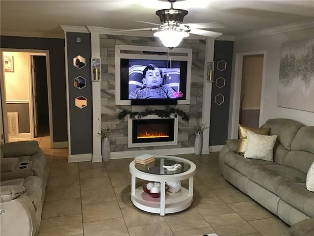 living area with a ceiling fan, a fireplace, crown molding, and baseboards