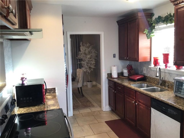 kitchen featuring black microwave, dishwashing machine, range with electric cooktop, a sink, and dark countertops