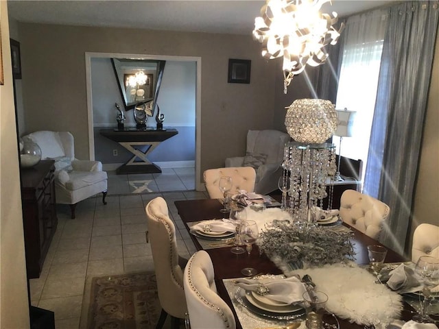 tiled dining room with an inviting chandelier