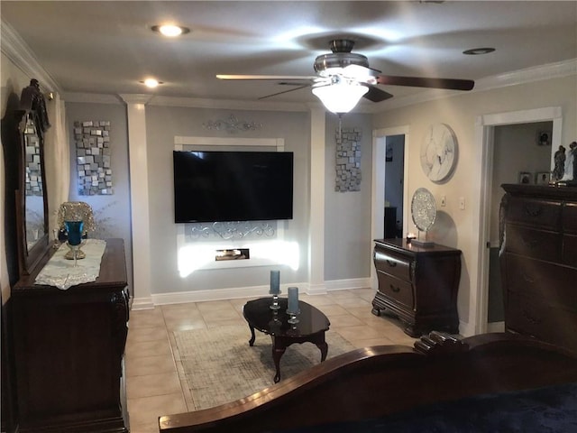 living area with light tile patterned floors, ceiling fan, ornamental molding, and baseboards