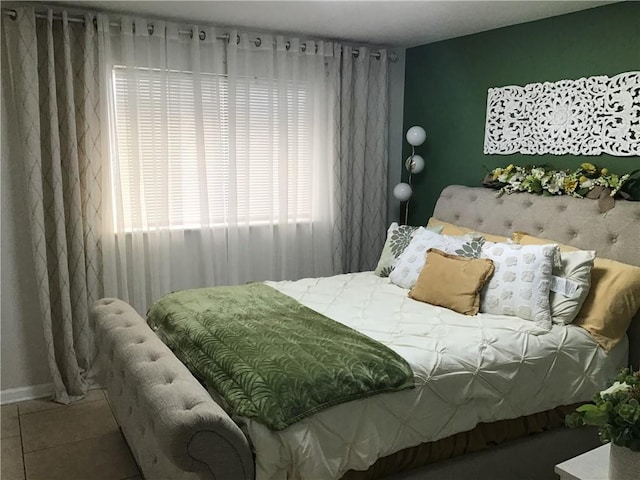 tiled bedroom featuring baseboards