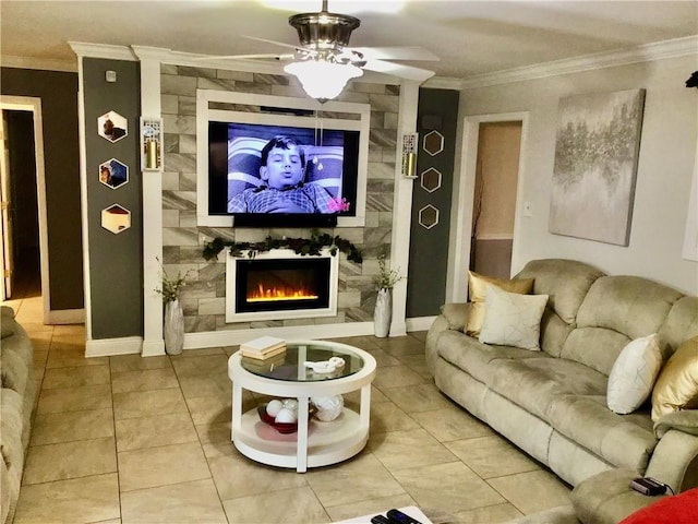 living area with crown molding, a ceiling fan, a large fireplace, light tile patterned floors, and baseboards