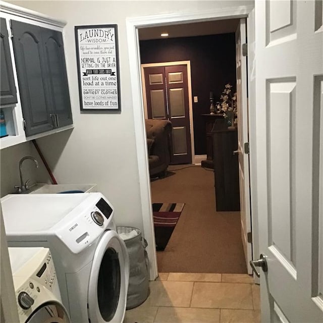 laundry room with washer and dryer, cabinet space, a sink, and light tile patterned flooring