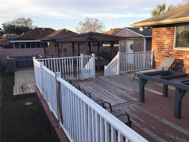 wooden terrace featuring fence