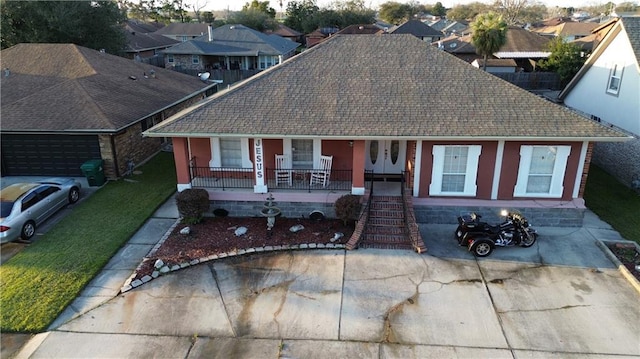 view of front of house with a porch, a residential view, and a shingled roof