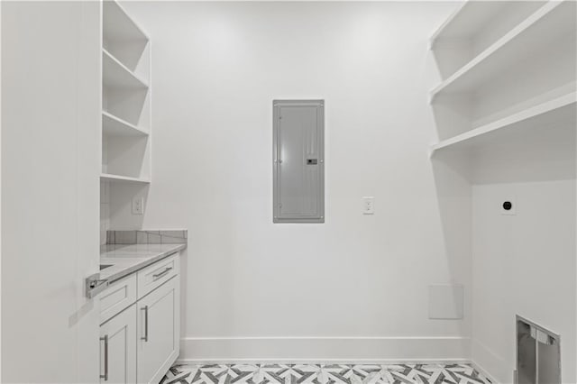 washroom featuring baseboards, laundry area, electric panel, and hookup for an electric dryer