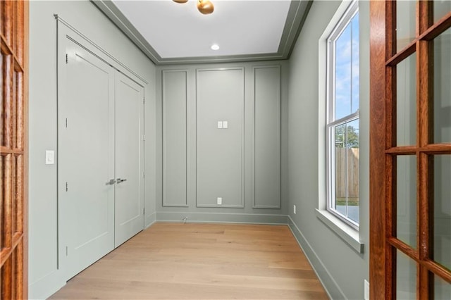 interior space featuring light wood-style floors and a decorative wall