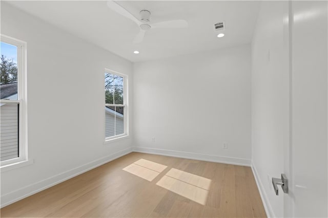 empty room with recessed lighting, visible vents, a ceiling fan, light wood-type flooring, and baseboards