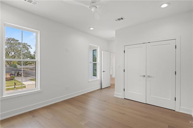 unfurnished bedroom with visible vents, baseboards, light wood-style flooring, a closet, and recessed lighting