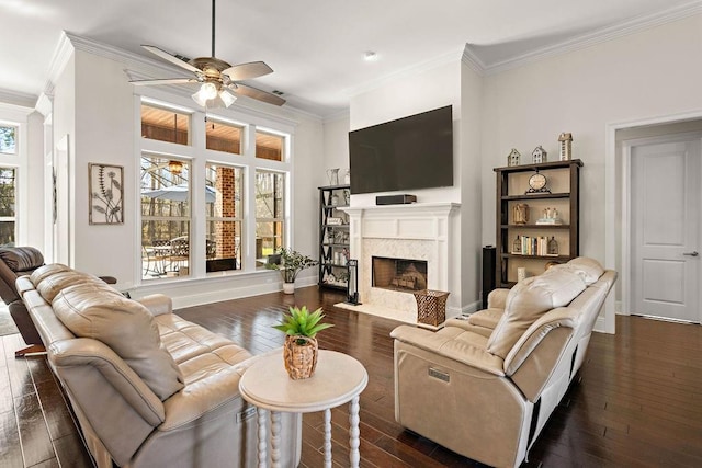 living area featuring ornamental molding, dark wood finished floors, and a high end fireplace