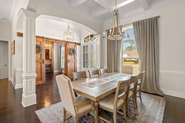 dining room featuring a barn door, dark wood-type flooring, coffered ceiling, beamed ceiling, and decorative columns