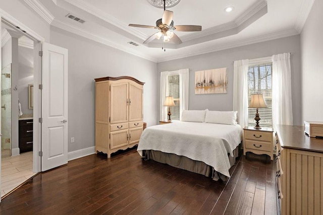 bedroom featuring dark wood-style floors, a raised ceiling, visible vents, and crown molding