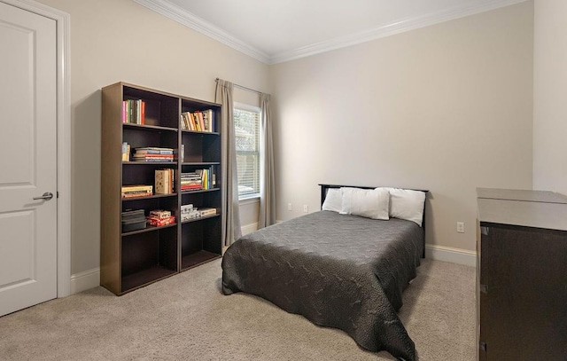 bedroom with ornamental molding, carpet flooring, and baseboards