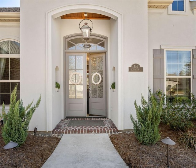 property entrance featuring stucco siding